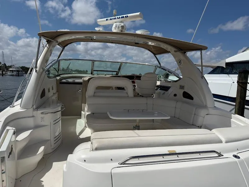 Slide: The Image of 2000 Sea Ray 510 Sundancer yacht with spacious seating and canopy under a clear sky. - 4