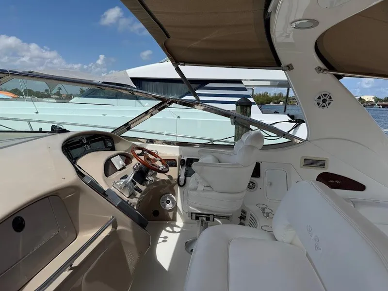 Slide: The Image of Interior view of a 2000 Sea Ray 510 Sundancer yacht cockpit with steering wheel and seating. - 9