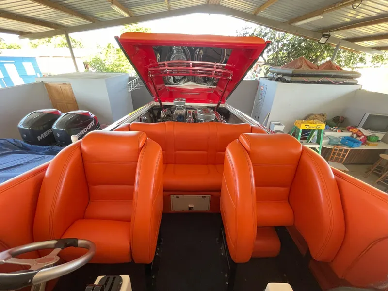 Slide: The Image of 2002 Cigarette ROUGH RIDER boat with vibrant orange interior and open engine compartment. - 14