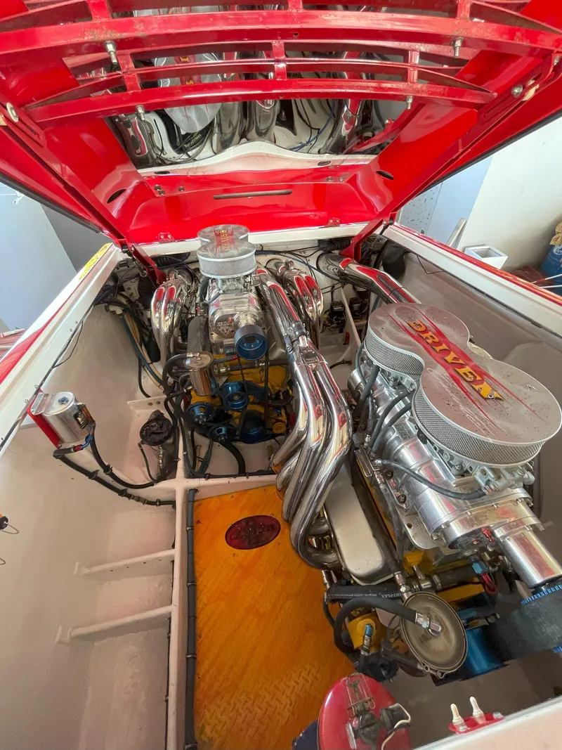 Slide: The Image of Engine compartment of a 2002 Cigarette Rough Rider boat, showcasing dual high-performance engines. - 7