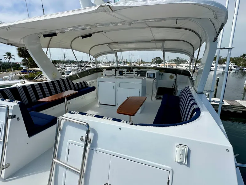 Slide: The Image of Spacious deck of 2002 Jefferson Marquessa 57 MY yacht with seating and tables. - 11