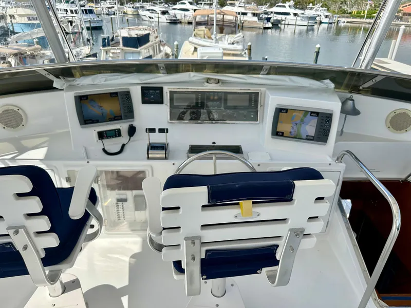 Slide: The Image of Helm of 2002 Jefferson Marquessa 57 MY yacht with navigation equipment and marina view. - 15