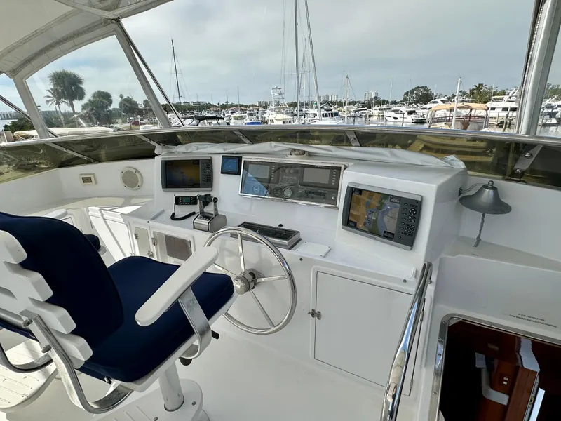 Slide: The Image of Helm of 2002 Jefferson Marquessa 57 MY yacht with navigation equipment and blue captain's chair. - 16