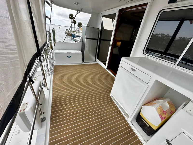 Slide: The Image of Spacious deck of 2002 Jefferson Marquessa 57 MY yacht with storage and seating. - 18