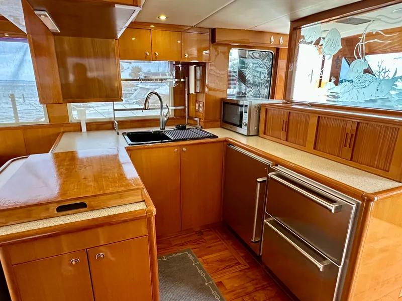 Slide: The Image of Luxurious kitchen interior of 2002 Jefferson Marquessa 57 MY yacht with wood cabinetry and modern appliances. - 32