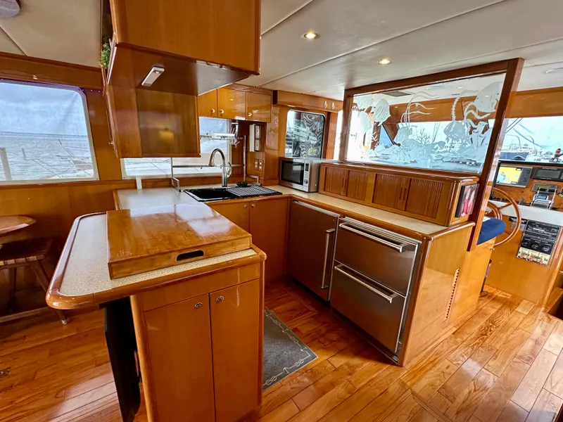 Slide: The Image of Luxurious 2002 Jefferson Marquessa 57 MY yacht kitchen with wood cabinetry and modern appliances. - 33