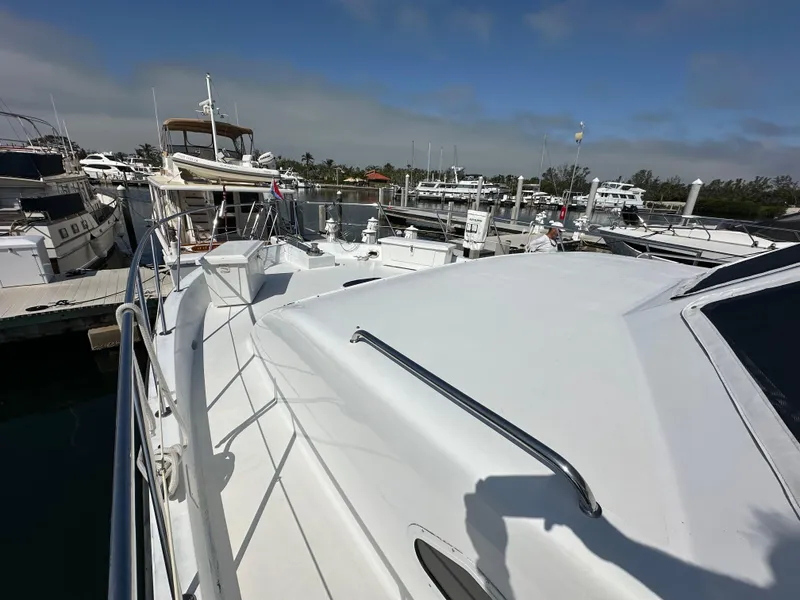 Slide: The Image of 2002 Jefferson Marquessa 57 MY yacht docked at a marina under clear skies. - 6
