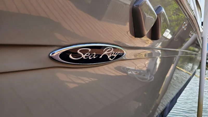 Slide: The Image of 2007 Sea Ray 340 Sundancer boat with logo, docked by the water. - 4