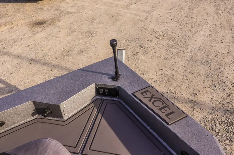 Slide: The Image of 2026 Excel 220 Bay Pro Elite boat deck with control lever and logo. - 12