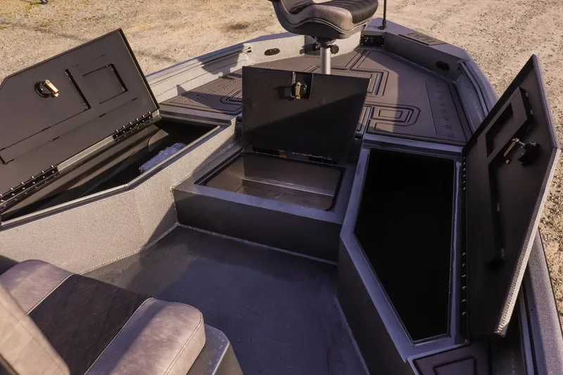 Slide: The Image of 2026 Excel 220 Bay Pro Elite boat interior with open storage compartments and seating. - 21
