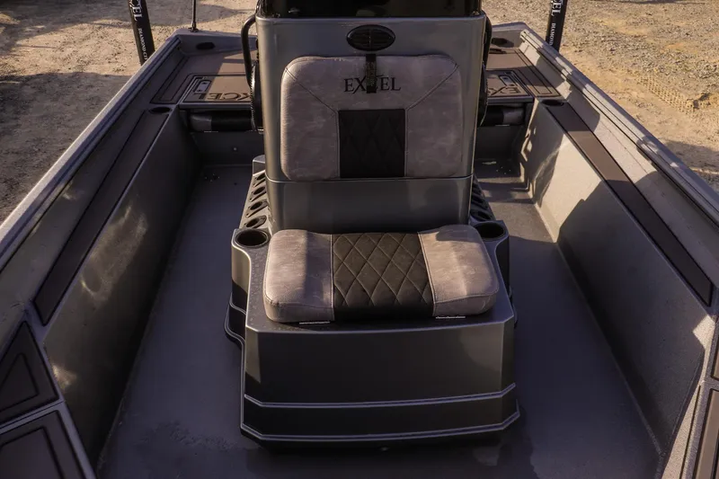 Slide: The Image of 2026 Excel 220 Bay Pro Elite boat interior with cushioned seating and storage compartments. - 22
