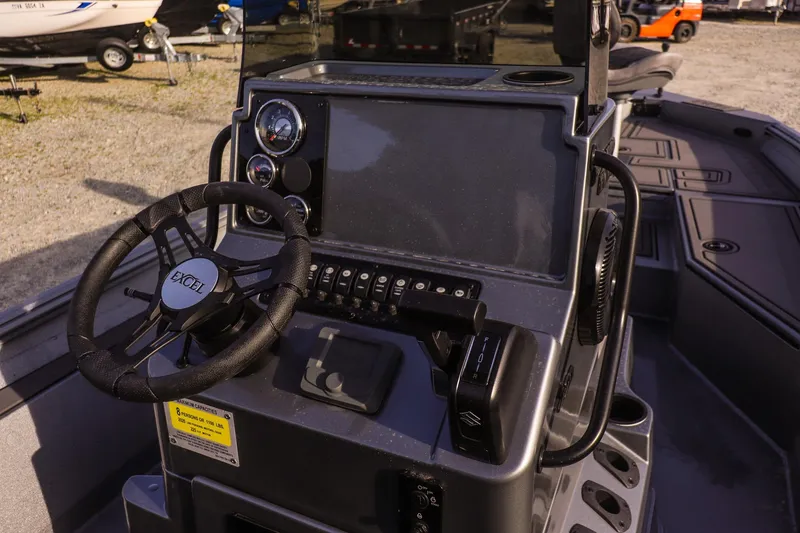 Slide: The Image of 2026 Excel 220 Bay Pro Elite boat dashboard with steering wheel and control panel. - 23