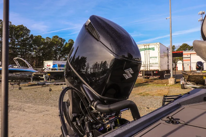 Slide: The Image of 2026 Excel 220 Bay Pro Elite boat with powerful outboard motor in a marina setting. - 24