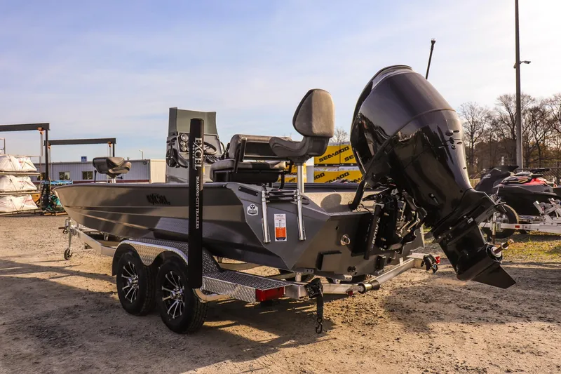 Slide: The Image of 2026 Excel 220 Bay Pro Elite boat on trailer, outdoor display. - 4
