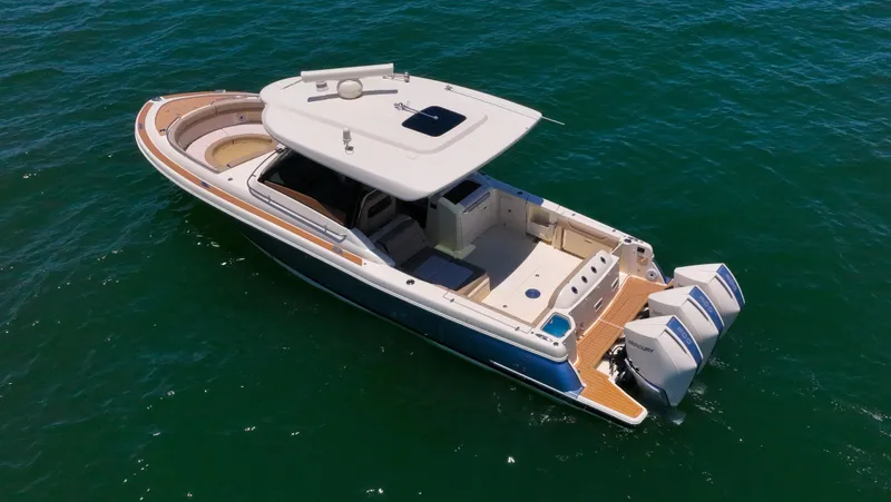 Slide: The Image of 2022 Chris-Craft Calypso 35 boat on open water, featuring triple outboard engines. - 11