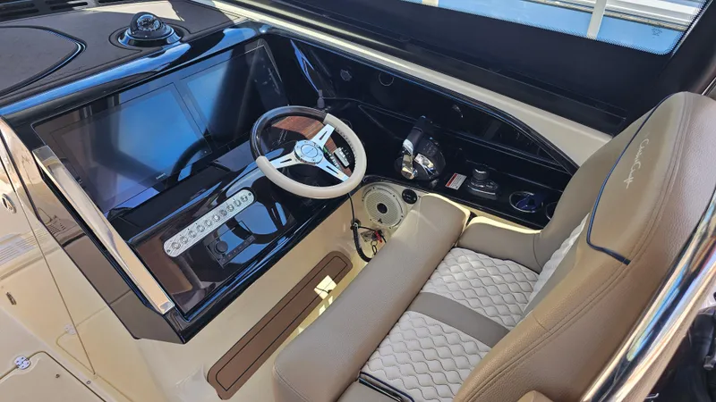 Slide: The Image of 2022 Chris-Craft Calypso 35 helm with modern steering wheel and control panel. - 14