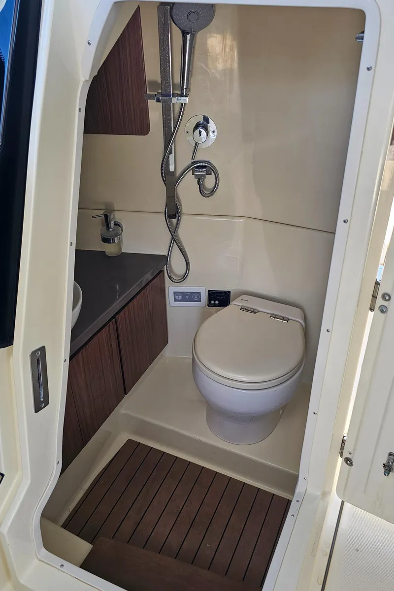 Slide: The Image of 2022 Chris-Craft Calypso 35 boat bathroom with shower, toilet, and wooden flooring. - 19