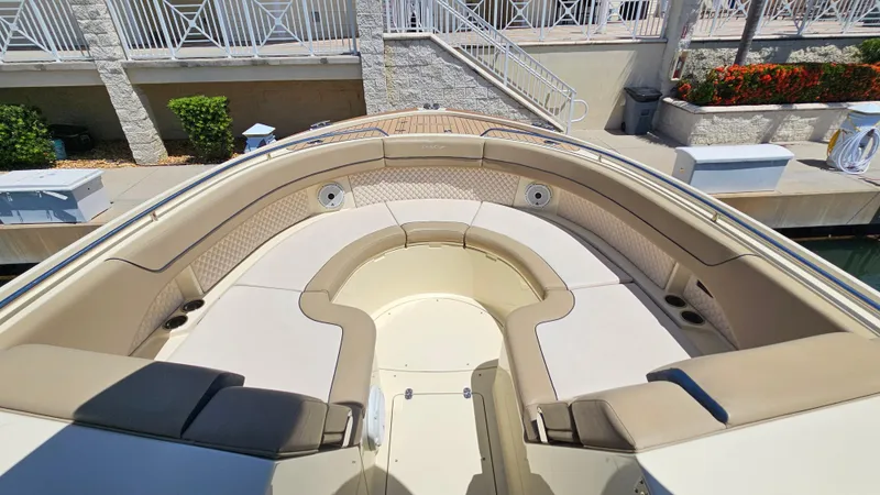 Slide: The Image of 2022 Chris-Craft Calypso 35 boat with spacious seating and elegant design at a dock. - 22