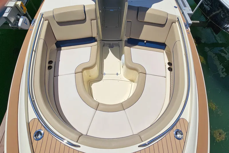 Slide: The Image of 2022 Chris-Craft Calypso 35 boat interior with beige seating and teak accents. - 25