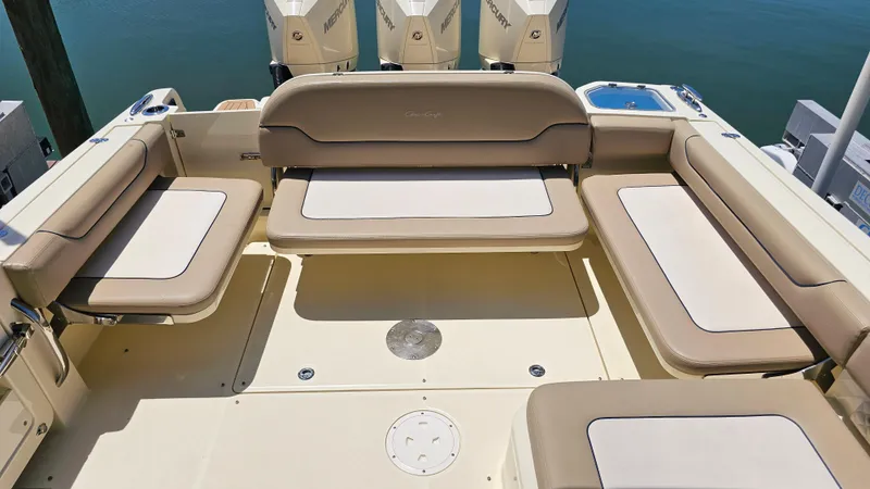 Slide: The Image of 2022 Chris-Craft Calypso 35 boat interior with beige seating and Mercury engines. - 28