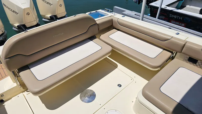 Slide: The Image of 2022 Chris-Craft Calypso 35 boat seating area with beige cushions and Mercury engines. - 31