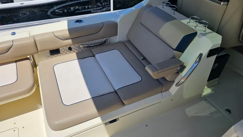 Slide: The Image of 2022 Chris-Craft Calypso 35 boat interior with beige seating and cup holders. - 33