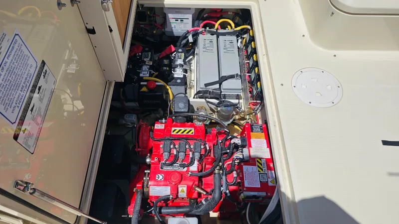 Slide: The Image of Engine compartment of 2022 Chris-Craft Calypso 35, showcasing batteries and wiring. - 37