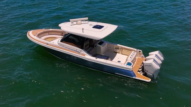 Slide: The Image of 2022 Chris-Craft Calypso 35 boat on open water, featuring sleek design and powerful engines. - 4