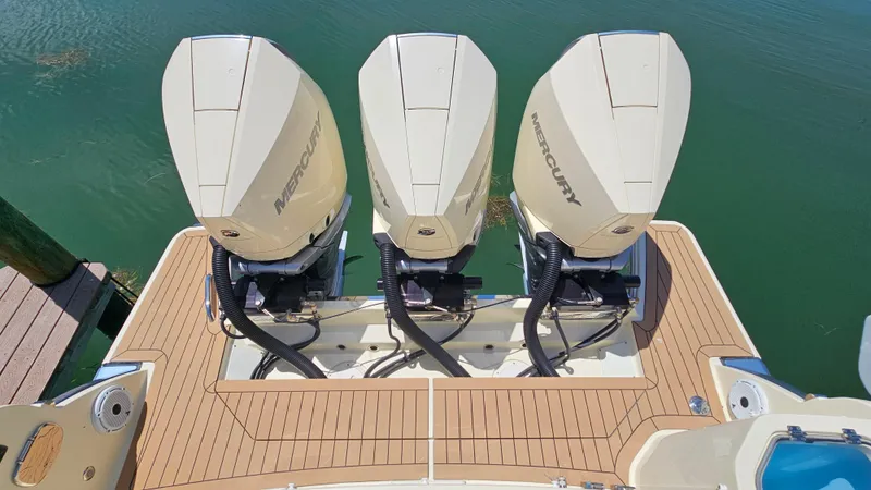 Slide: The Image of 2022 Chris-Craft Calypso 35 with triple Mercury outboard engines on teak deck. - 40