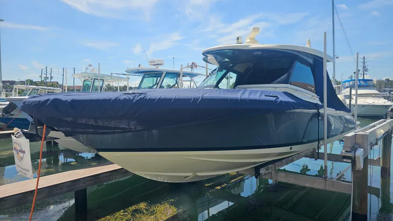 Slide: The Image of 2022 Chris-Craft Calypso 35 boat docked, covered, and elevated at a marina. - 41