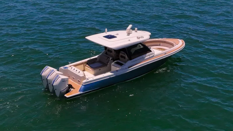 Slide: The Image of 2022 Chris-Craft Calypso 35 boat on open water, featuring dual outboard engines. - 6