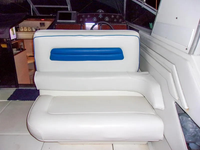 Slide: The Image of 1992 Sea Ray 400 Express Cruiser interior with white and blue seating. - 10