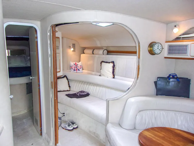 Slide: The Image of Interior of 1992 Sea Ray 400 Express Cruiser, featuring cozy seating and nautical decor. - 17