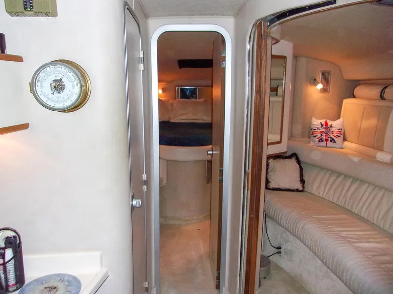 Slide: The Image of Interior of 1992 Sea Ray 400 Express Cruiser with cozy seating and nautical decor. - 21