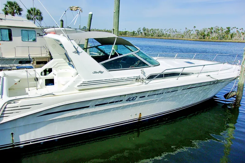Slide: The Image of 1992 Sea Ray 400 Express Cruiser docked in a marina. - 4