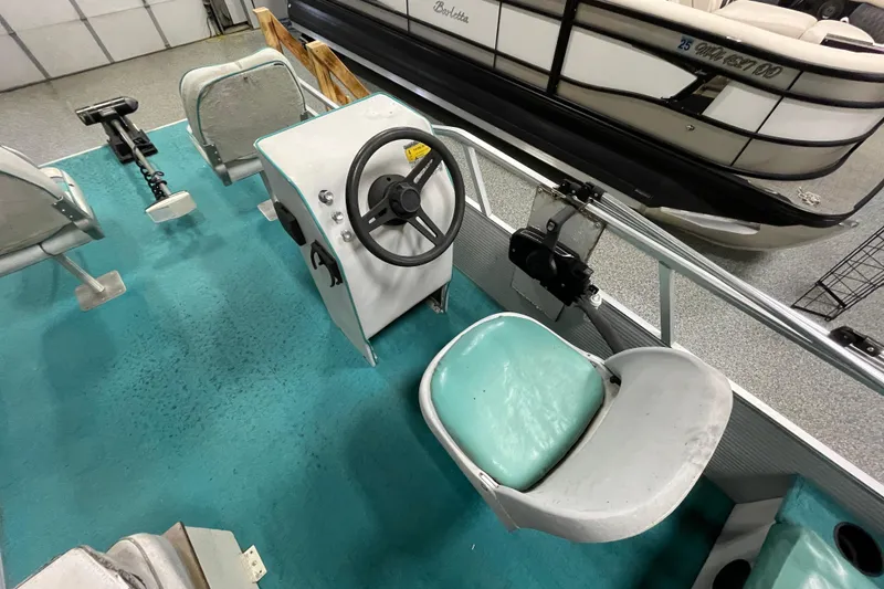 Slide: The Image of 1995 Weeres Fish 16 boat interior with steering wheel and seating. - 10