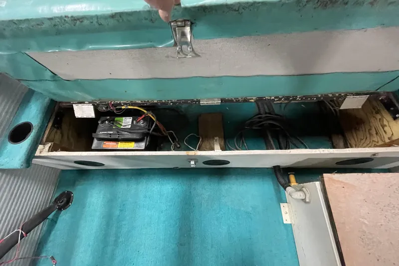 Slide: The Image of Interior view of a 1995 Weeres Fish 16 boat showing battery and wiring compartment. - 12