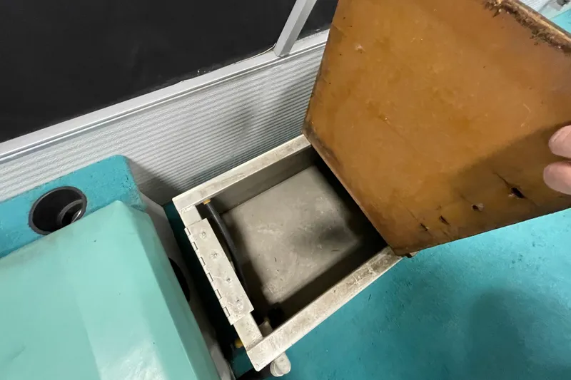 Slide: The Image of Open storage compartment on 1995 Weeres Fish 16 boat, showing interior details. - 13