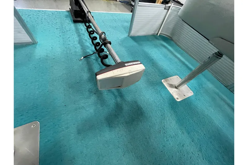 Slide: The Image of 1995 Weeres Fish 16 boat interior with trolling motor on blue carpet. - 15