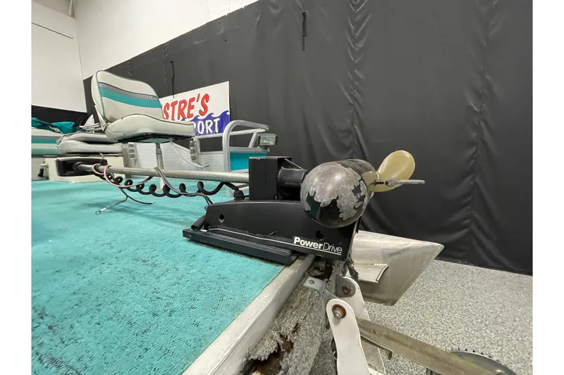 Slide: The Image of 1995 Weeres Fish 16 boat with PowerDrive motor and teal seating. - 16