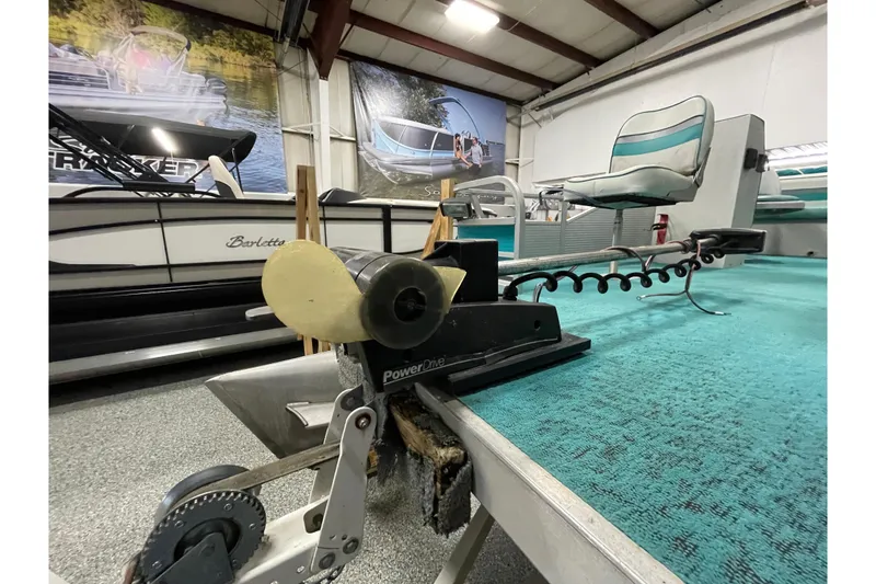 Slide: The Image of 1995 Weeres Fish 16 pontoon boat with trolling motor in showroom. - 17