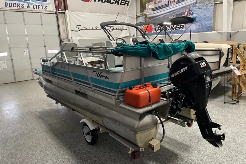 Slide: The Image of 1995 Weeres Fish 16 pontoon boat with Mercury 25 outboard motor in showroom. - 4