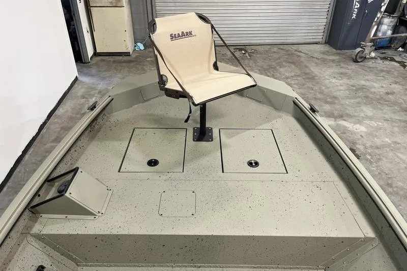 Slide: The Image of 2025 SeaArk Shadow 18T boat interior with swivel seat and storage compartments. - 12