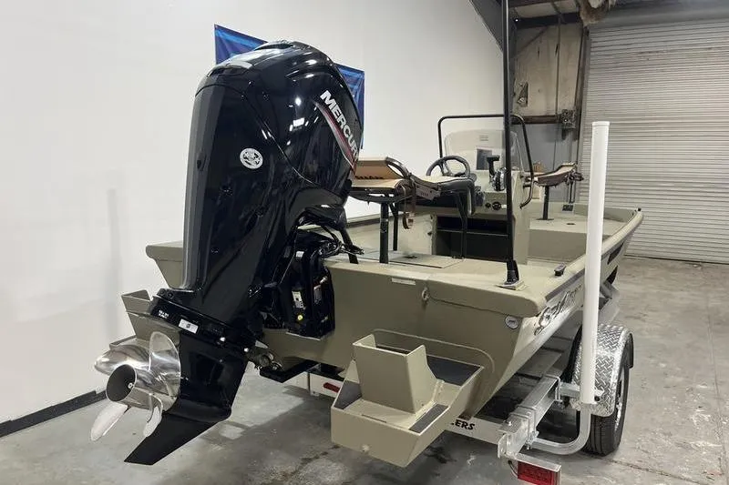 Slide: The Image of 2025 SeaArk Shadow 18T boat with Mercury outboard motor in a garage setting. - 3