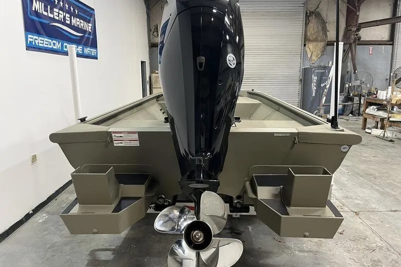 Slide: The Image of 2025 SeaArk Shadow 18T boat with outboard motor in a garage setting. - 4