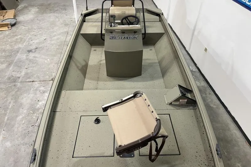 Slide: The Image of 2025 SeaArk Shadow 18T boat interior with steering console and seating. - 6