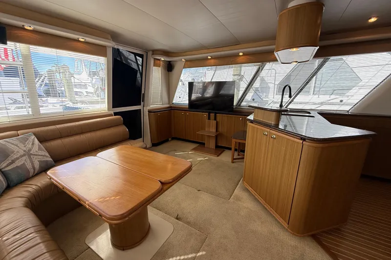 Slide: The Image of Luxurious interior of 2002 Bayliner 4788 Pilot House Motoryacht with elegant wood finishes. - 10