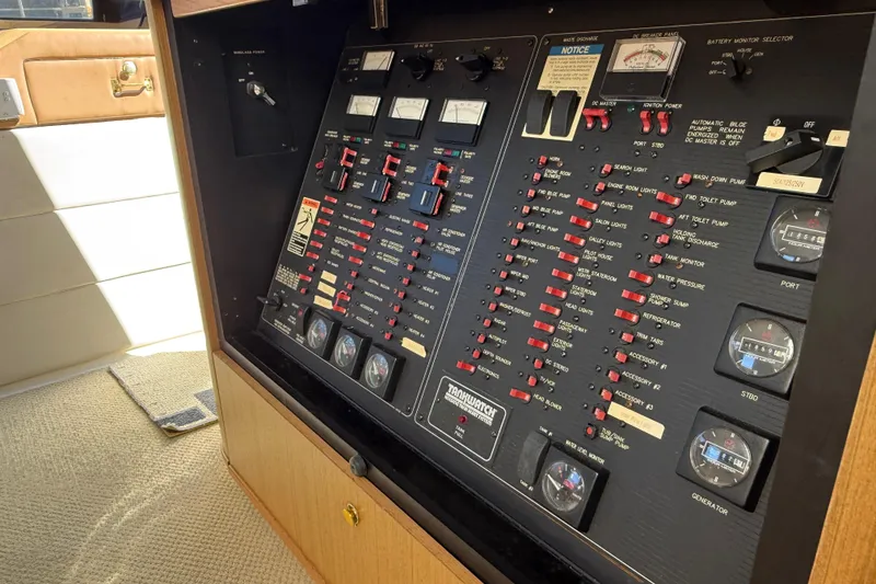 Slide: The Image of Control panel of a 2002 Bayliner 4788 Pilot House Motoryacht, featuring various switches and gauges. - 13