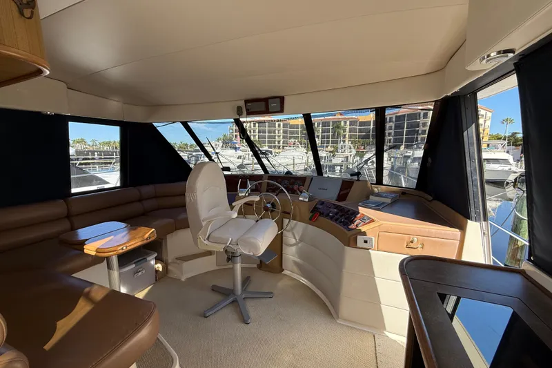 Slide: The Image of Interior of 2002 Bayliner 4788 Pilot House Motoryacht with helm and seating area. - 14