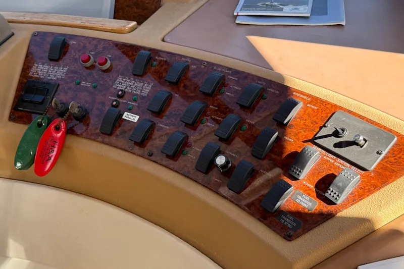 Slide: The Image of Control panel of a 2002 Bayliner 4788 Pilot House Motoryacht with switches and labels. - 15